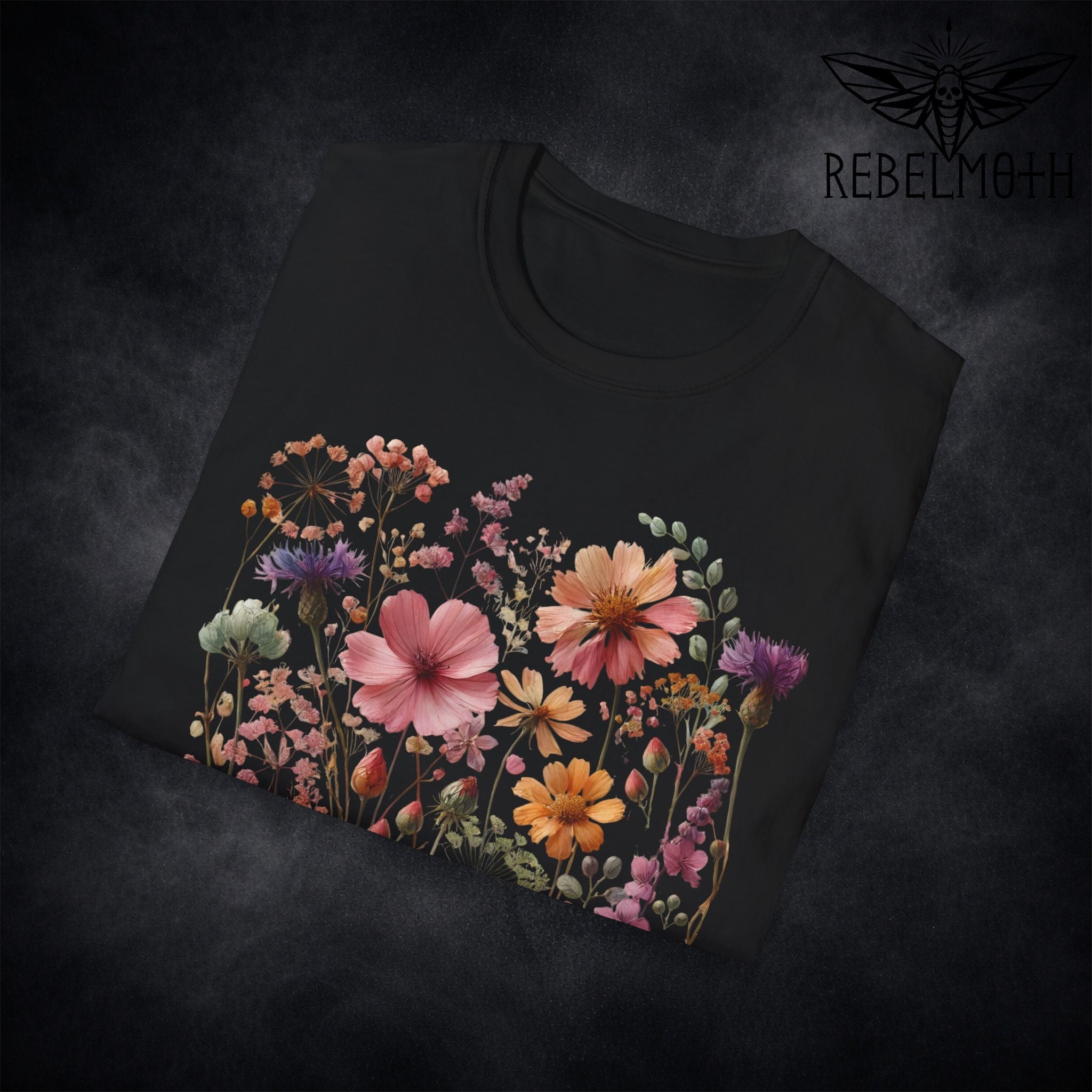 Close-up of colorful wildflower meadow print details on black t-shirt (botanical graphic)