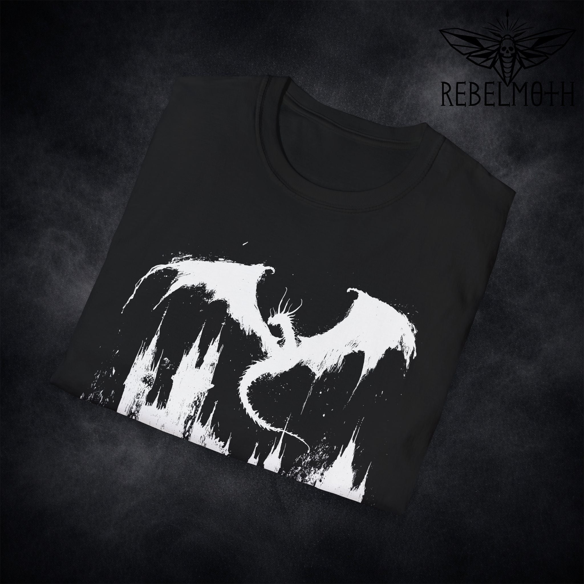 Flat lay of medieval dragon castle t-shirt with centered dark fantasy graphic