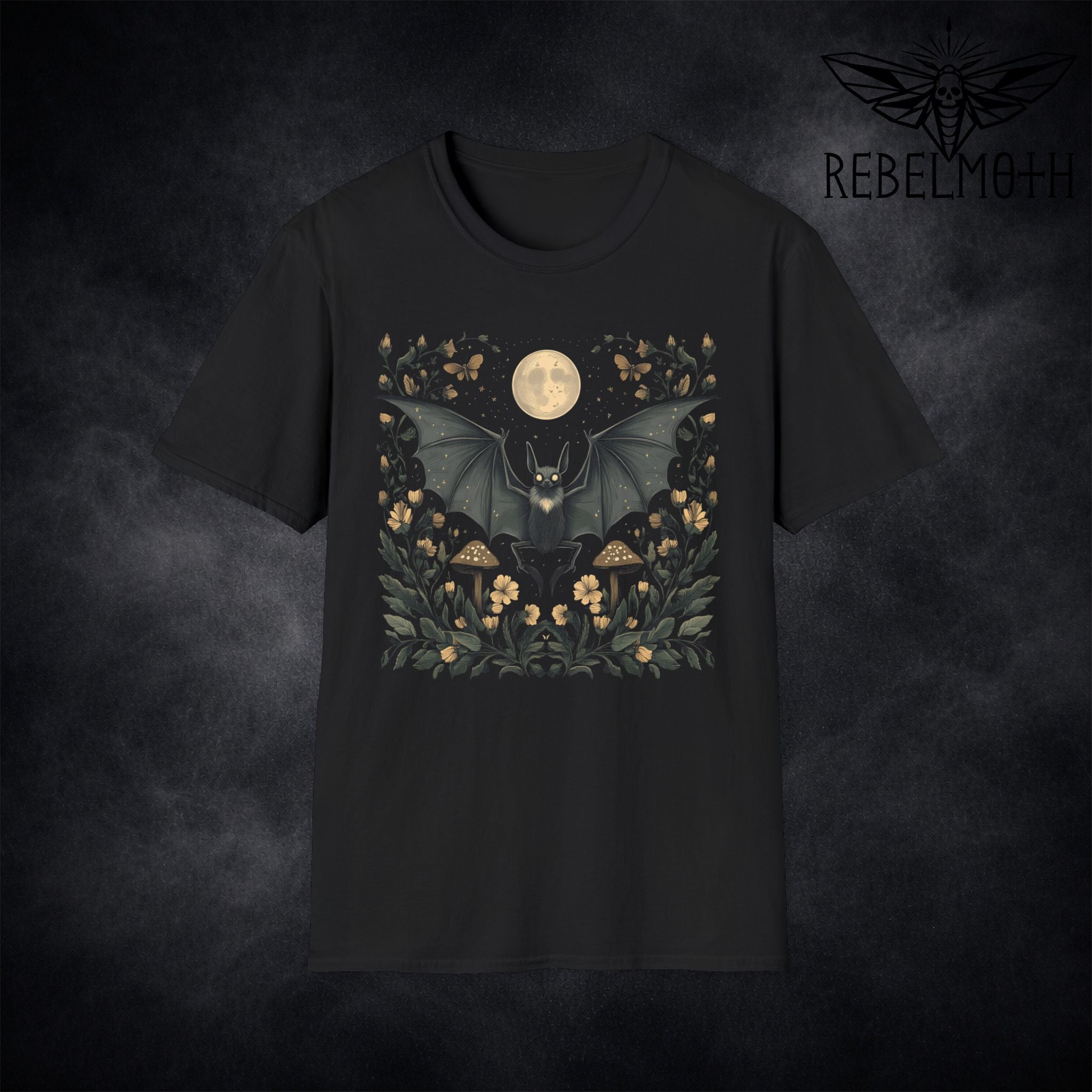 Black t-shirt with pastel goth bat under a full moon surrounded by flowers and mushrooms (floral moon graphic)