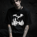Model wearing a Black t-shirt with medieval dragon coiled around a castle dark fantasy graphic (goth/metal style)