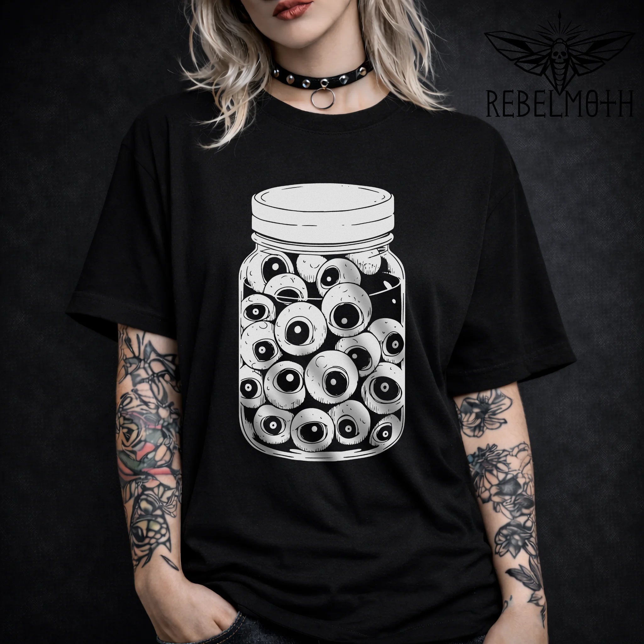 Eyeballs in a jar t-shirt with clean black-and-white line art. Weirdcore, goth-adjacent, trippy grunge graphic tee for alt streetwear fits.