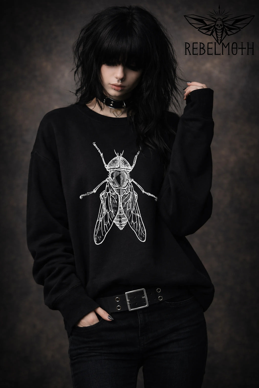 Woman wearing Black crewneck sweatshirt with vintage house fly insect illustration graphic in white line art (bug graphic)