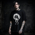 Model wearing a weird demon monster goth t-shirt with occult graphic, front view
