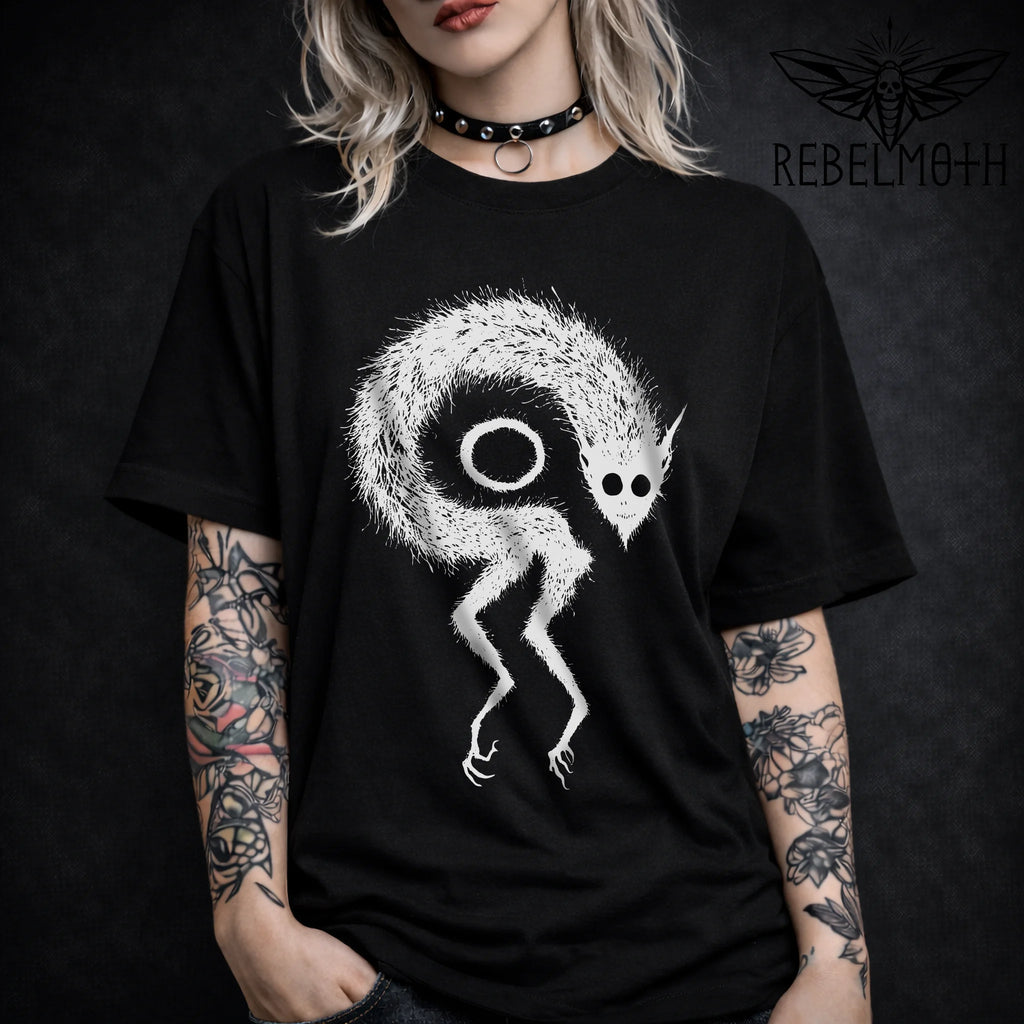 Woman wearing a Black t-shirt with weirdcore demon monster occult design