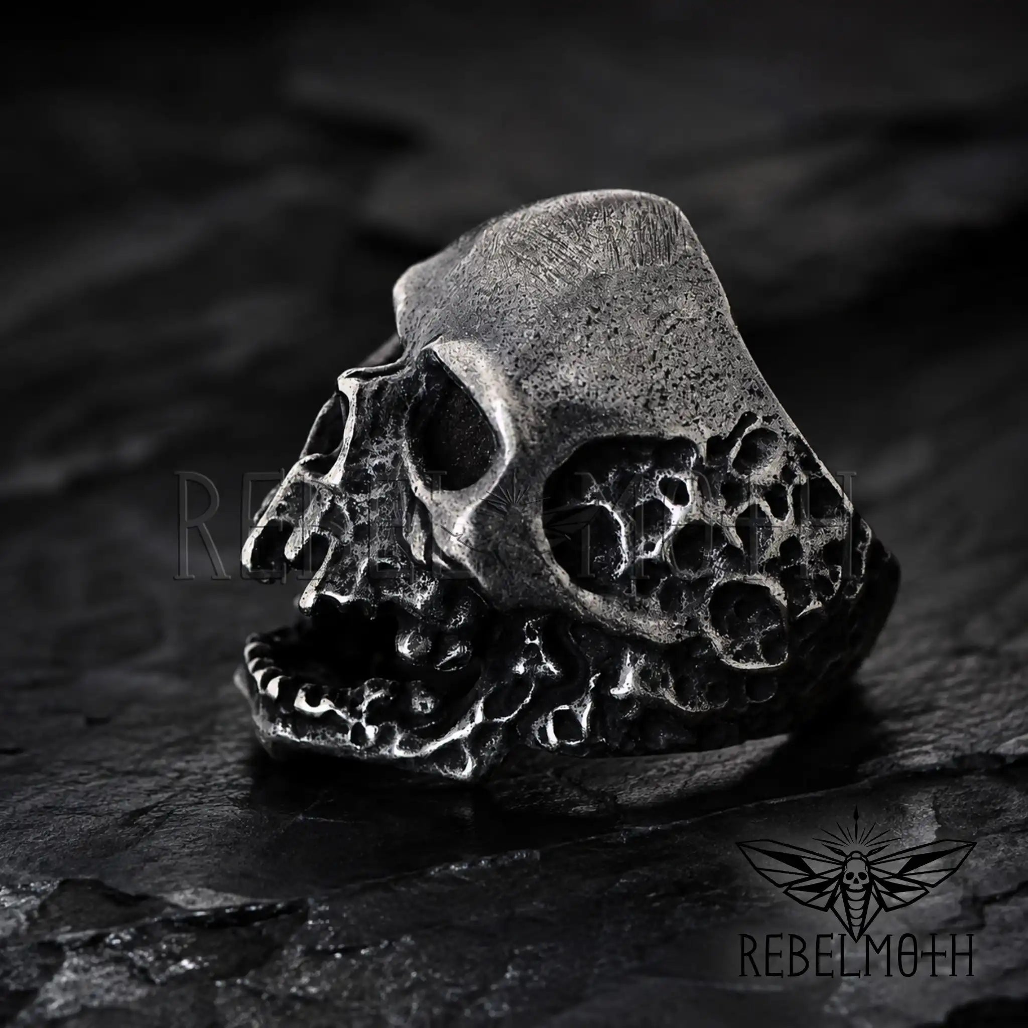 Heavy gothic skull statement ring on dark background