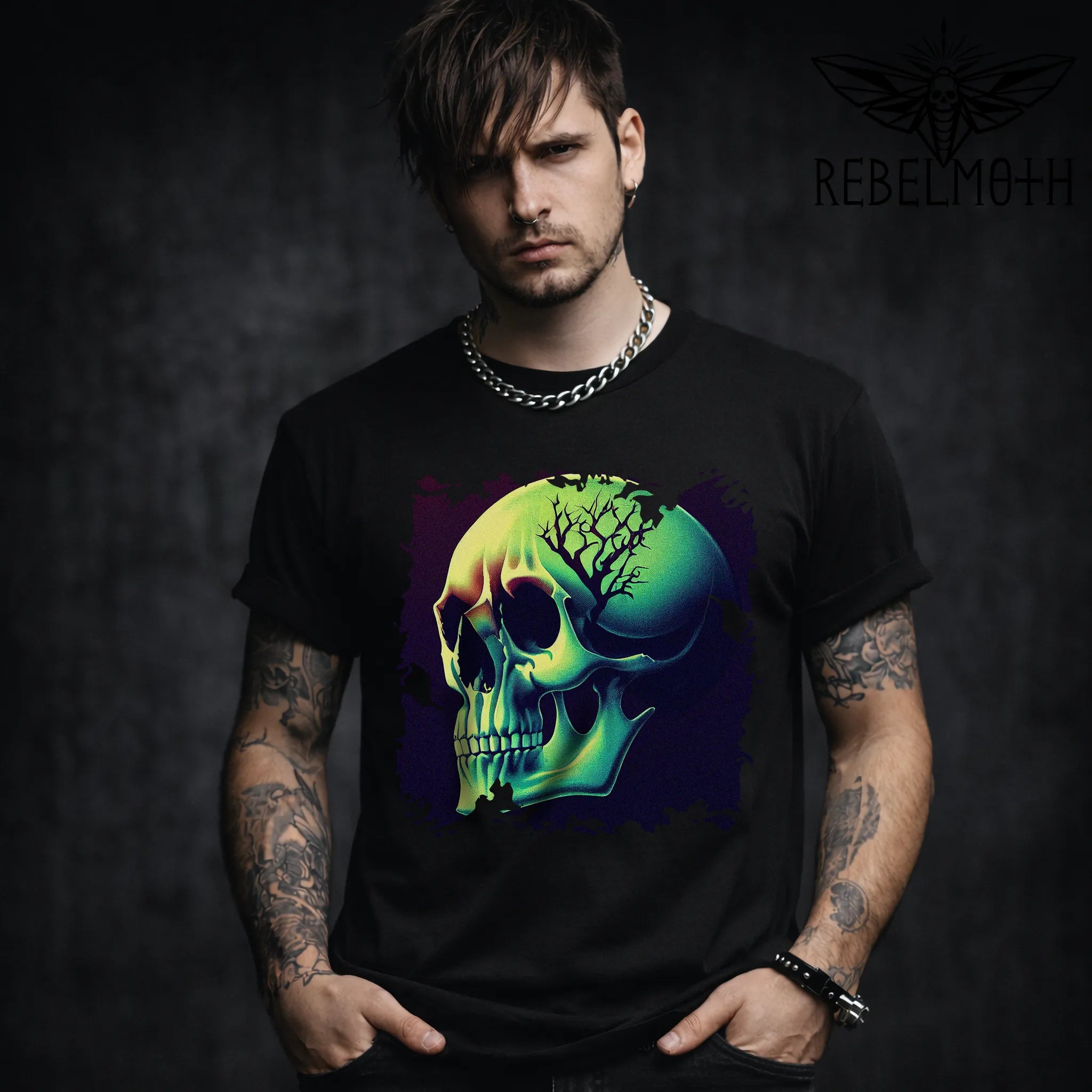 Man wearing a black t-shirt with a colorful skull design, standing against a dark background.