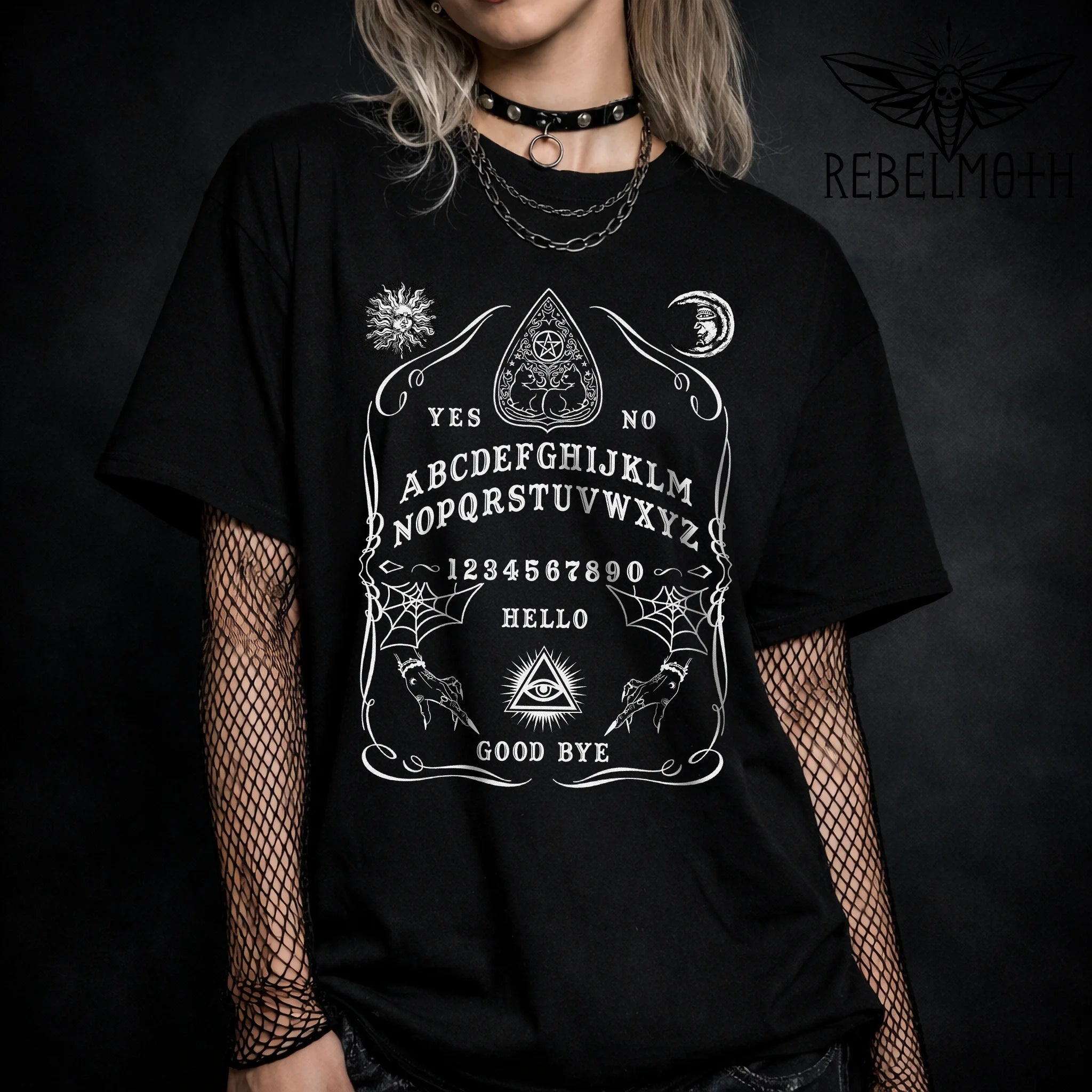 Ouija board t-shirt with a classic spirit board layout and occult symbols in bold black-and-white. Witchy goth graphic tee for alt outfits.