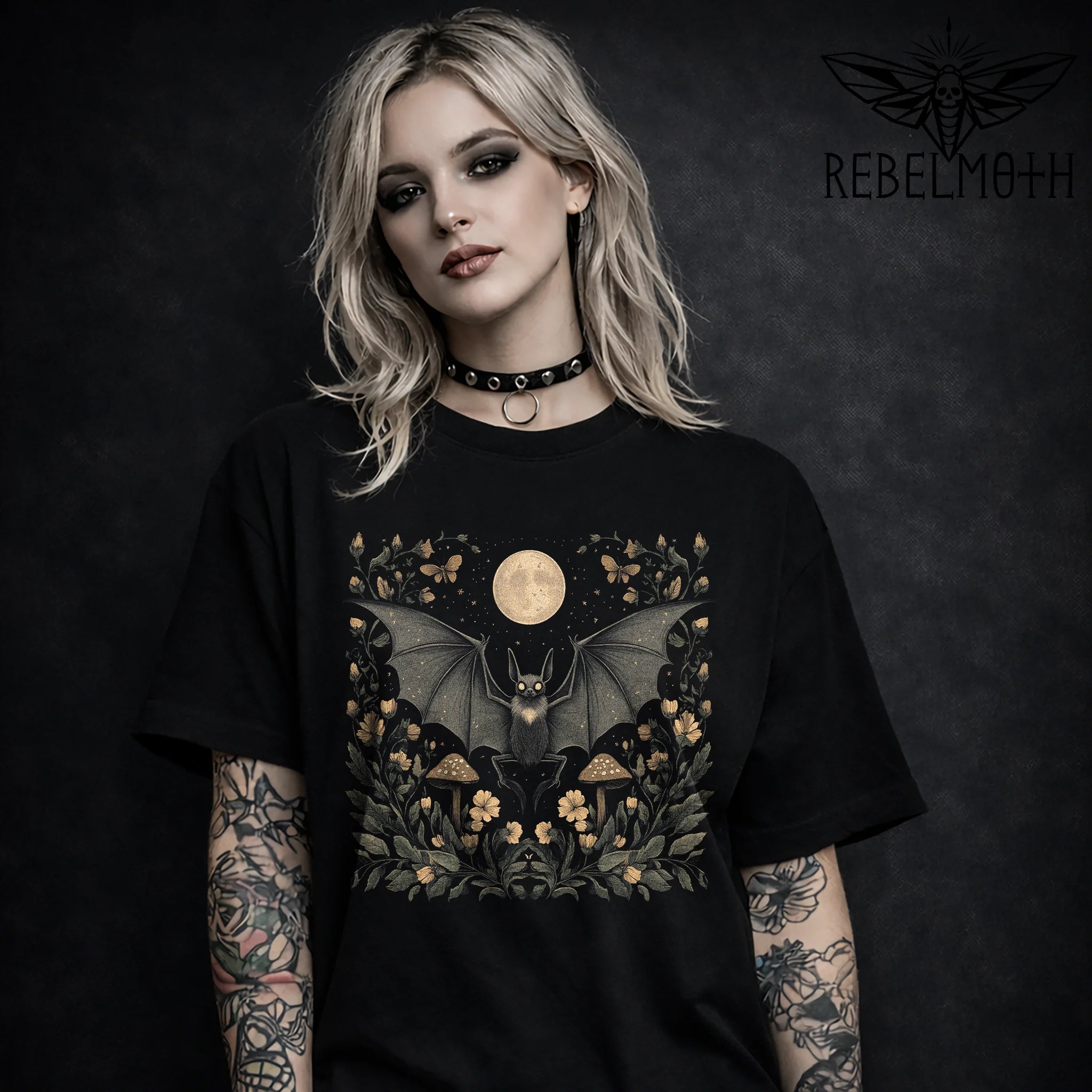 Pastel goth bat t-shirt with a full moon, flowers and mushrooms in a soft dark cottagecore style. Witchy floral graphic tee for alt outfits.