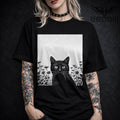 Woman wearing t-shirt with black cat in a wildflower garden vintage linoprint graphic (cat garden tee)