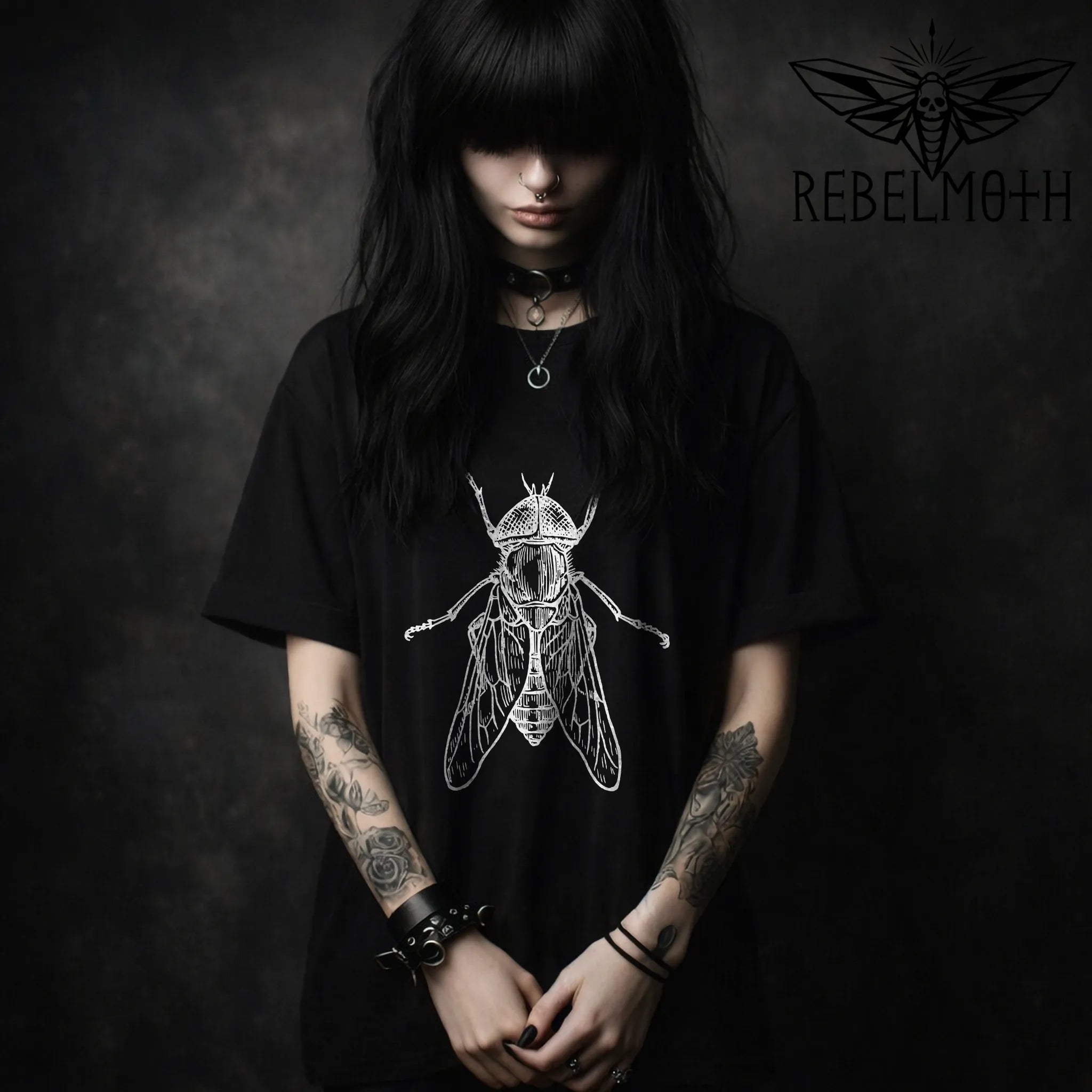 Woman wearing Black t-shirt with vintage house fly insect illustration graphic in white line art (minimal bug tee)