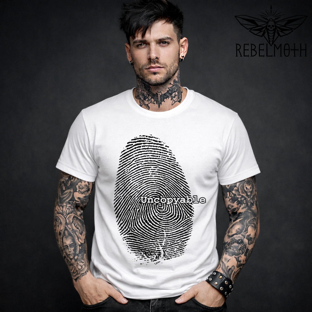 Man wearing a white grunge t-shirt with a fingerprint design and 'Uncopyable' text.
